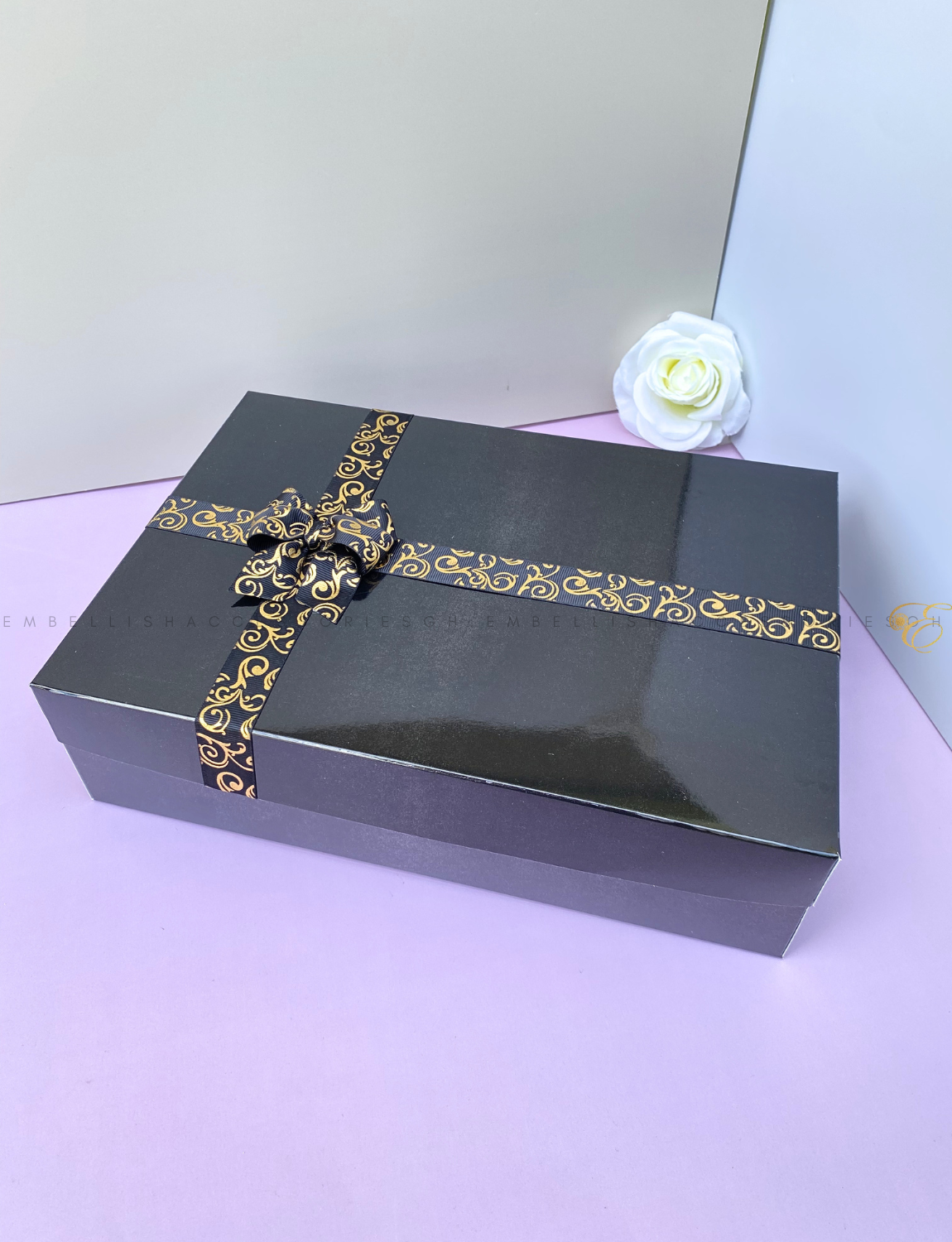 Black gift box E with gold speckled ribbon