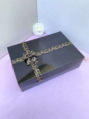 Black gift box E with gold speckled ribbon