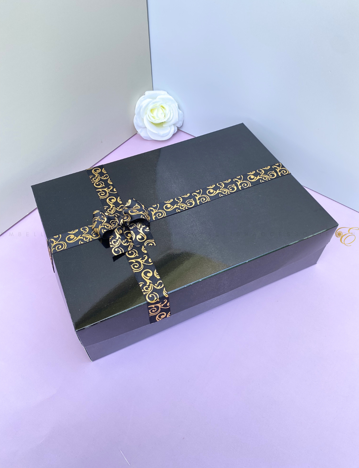 Black gift box E with gold speckled ribbon